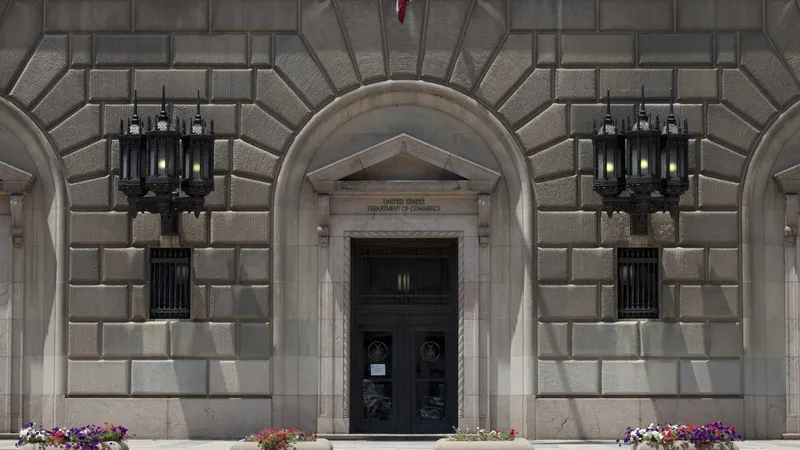 No copyright restriction The stone entrance of the U.S. Department of Commerce building, with lanterns and flower boxes.