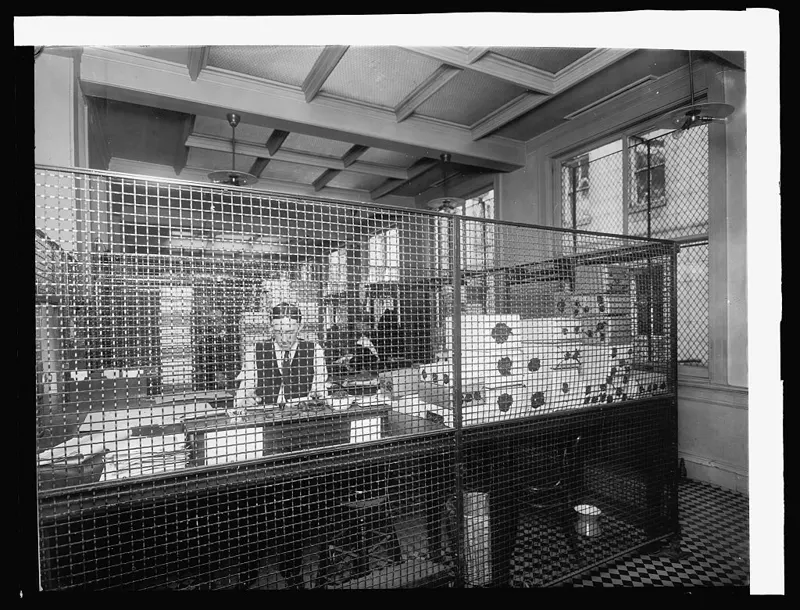 A clerk at work inside the paying tellers&rsquo; cage of the Treasury&rsquo;s National Bank Redemption Agency in 1914.