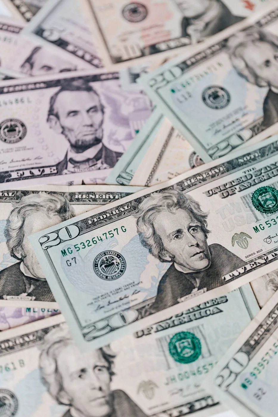 No copyright restriction A scattered pile of United States five-dollar and twenty-dollar bills.