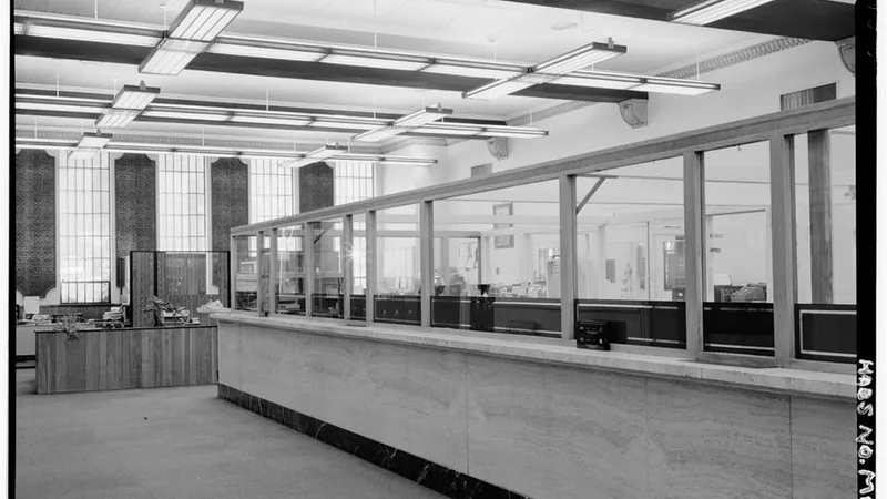 Teller windows along a stone counter at the Federal Reserve Bank of Minneapolis Helena Branch.