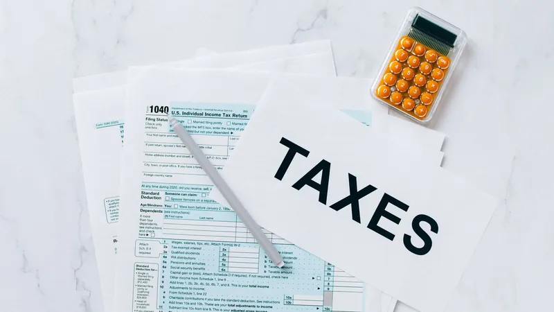 A 2020 Form 1040, U.S. Individual Income Tax Return, with a pen and a small calculator.