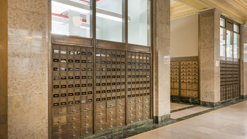 Brass post-office boxes set into a marble wall in the Texarkana U.S. Post Office and Federal Building.